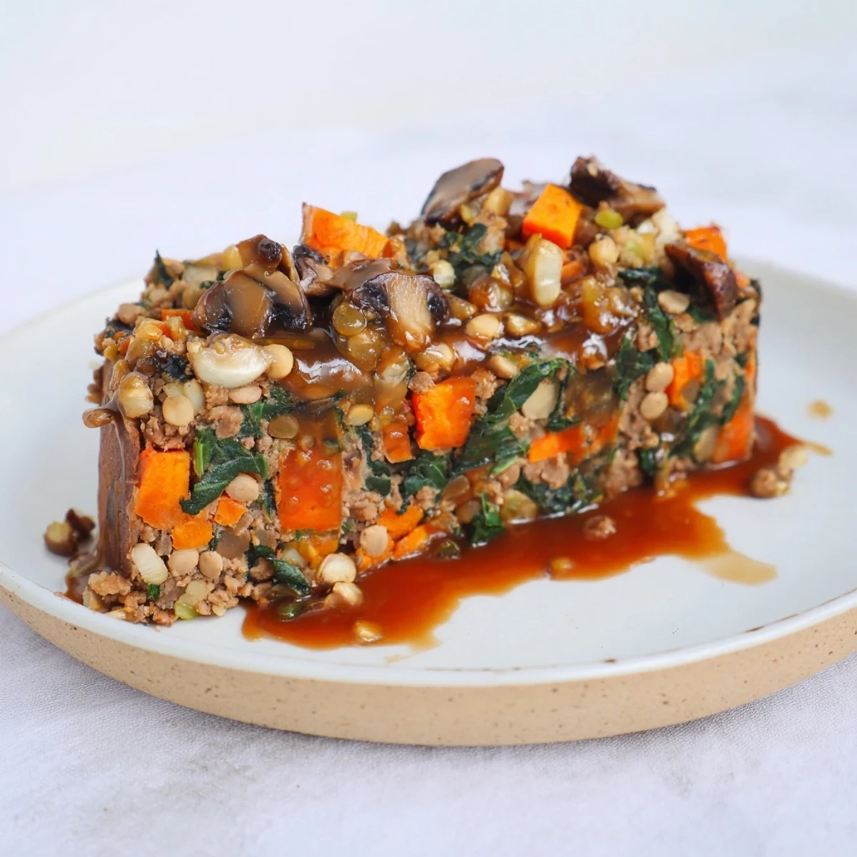 Close-up of a warm, fragrant Winter Garden Vegan Roast, with tender lentils and a golden crust.
