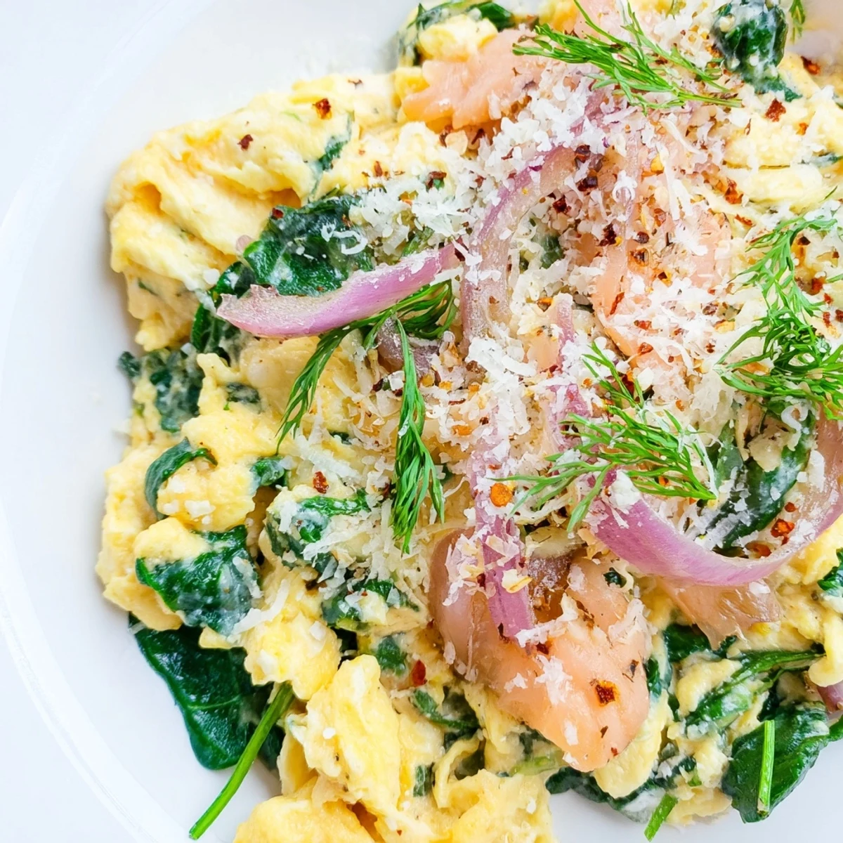 Savory low-carb Frosty Morning Main Dish with fluffy eggs, wilted spinach, and flaky salmon topped with fresh dill.