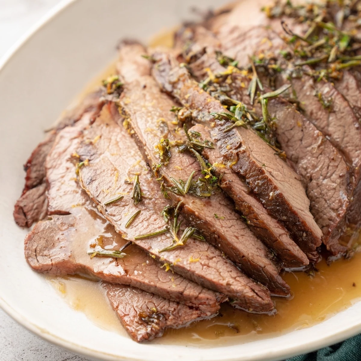 A golden Holiday Market Low Carb Roast rests beside caramelized vegetables, with a rich pan sauce drizzled over the top.