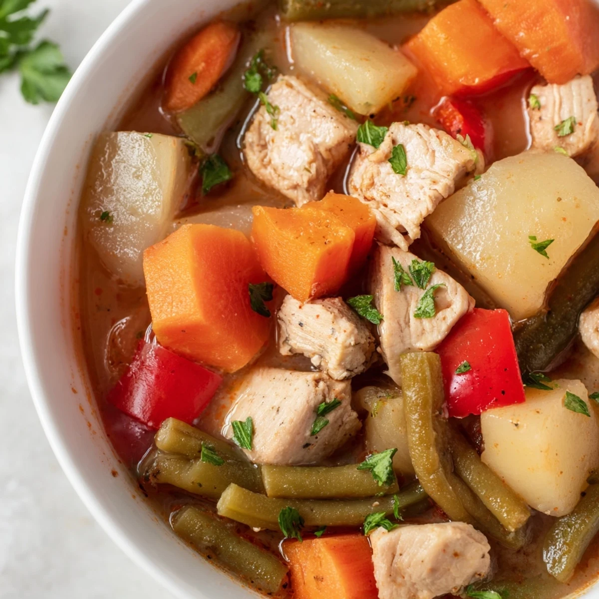 Close-up view of New Year Low Fat Stew simmering in a pot, showcasing chunks of carrots, celery, and red bell pepper for a healthy meal.
