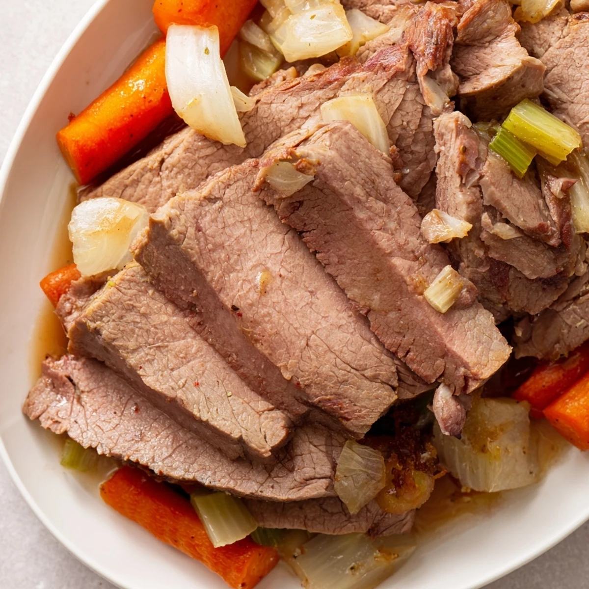Golden-brown, tender slices of Frosty Morning Low Fat Roast beef are arranged alongside roasted carrots and parsnips on a rustic wooden platter, garnished with fresh thyme.