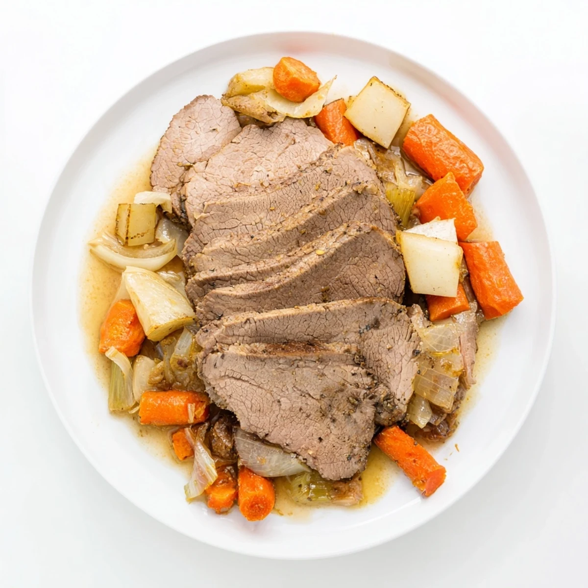 Frosty Morning Low Fat Roast served on a white plate with soft, herb-infused vegetables and a light, savory pan gravy drizzled over the meat.