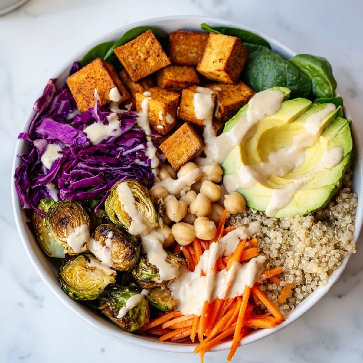 Overhead view of Winter Wellness High Protein Bowl with roasted sweet potato, crispy tofu, and tahini drizzle.