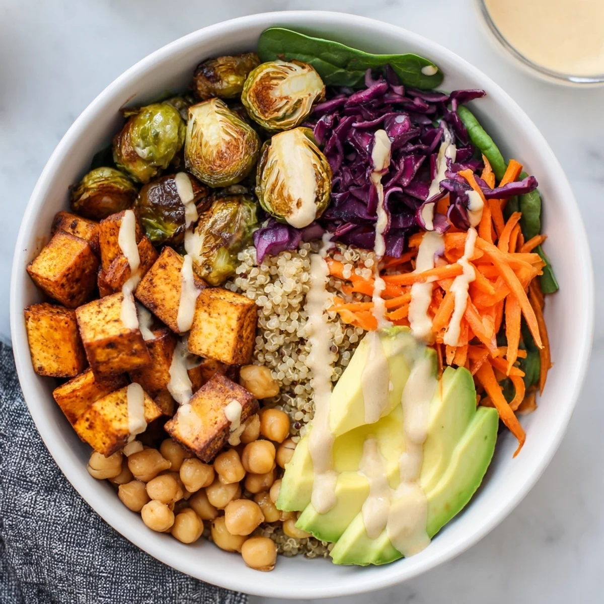 Close-up of Winter Wellness High Protein Bowl featuring colorful shredded cabbage, spinach, and golden Brussels sprouts.