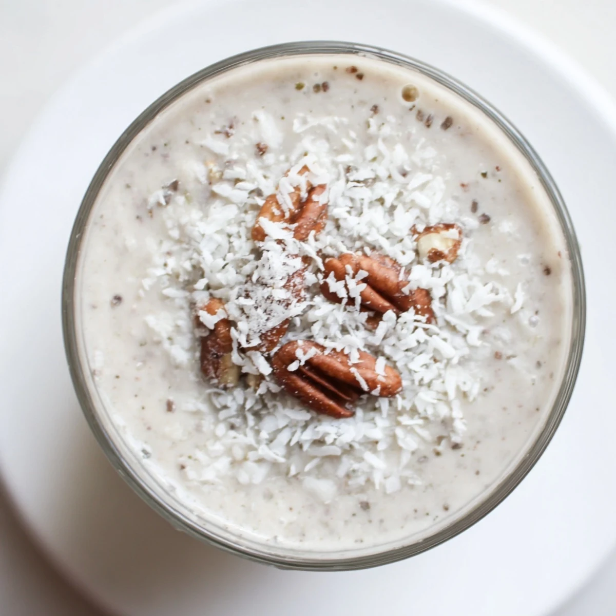 Enjoy this creamy Snowy Day Paleo Smoothie with almond butter and cinnamon in a tall glass, perfect for chilly mornings.