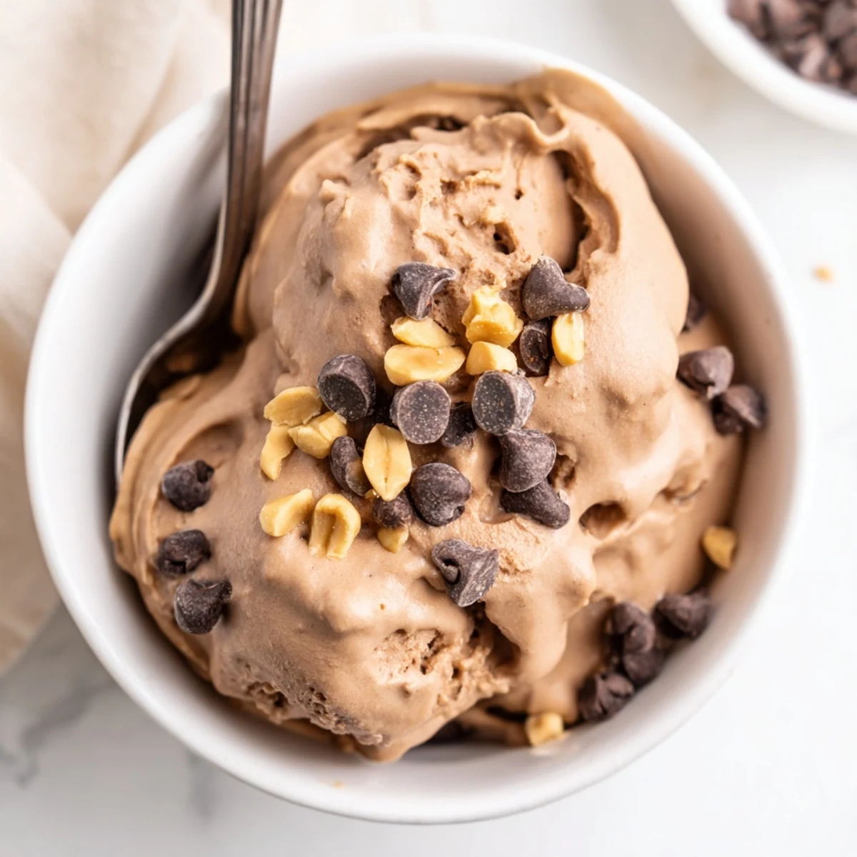 Creamy Chocolate Peanut Butter Protein Nice Cream swirl served immediately for a luscious soft-serve texture.