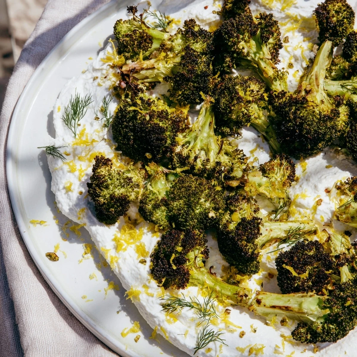 Golden roasted broccoli flolets arranged over creamy whipped feta topped with bright lemon zest