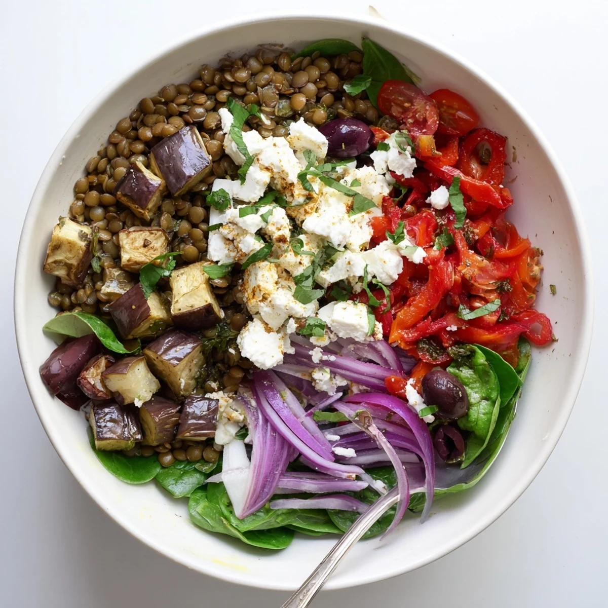 Wholesome Mediterranean lentil and roasted eggplant bowl with tender vegetables and tangy lemon dressing