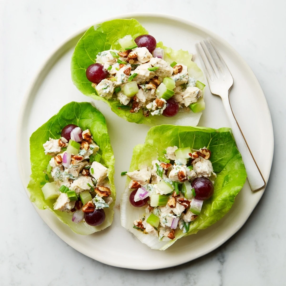 Protein-packed chicken salad with honey mustard dressing and cottage cheese served in refreshing crisp lettuce cups with diced vegetables
