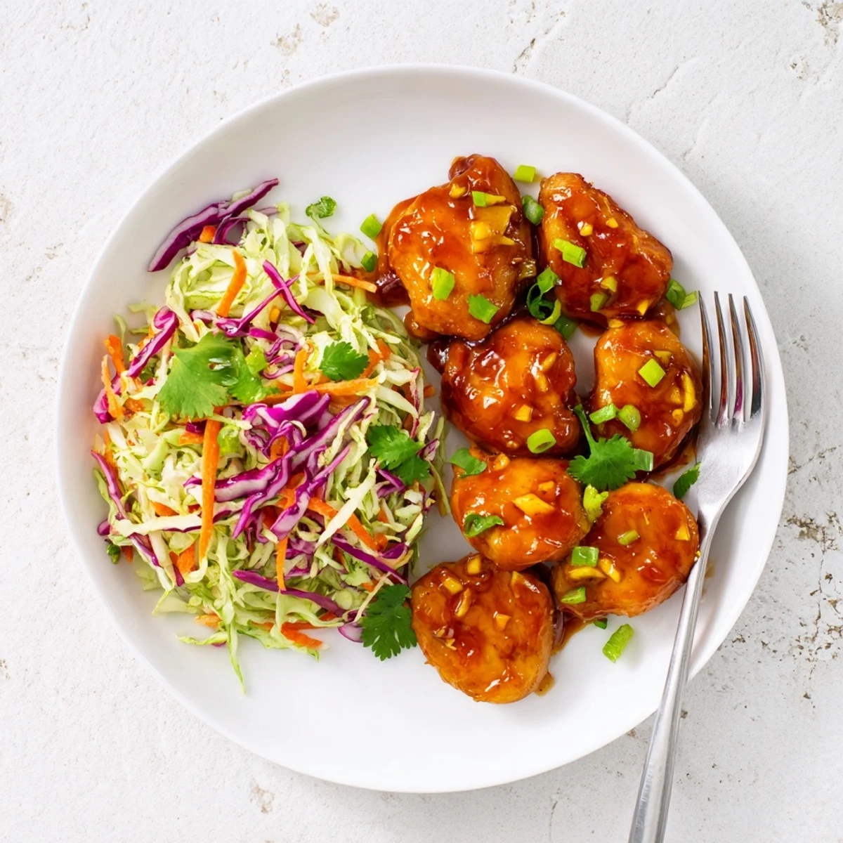 Sliced chicken breasts drizzled with sweet and spicy mango sauce atop crisp lime cabbage slaw