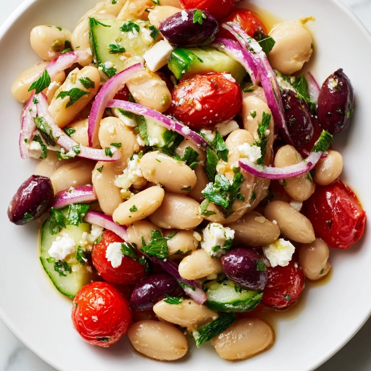 Creamy white beans and juicy tomatoes glistening with herb dressing in a Mediterranean White Bean and Tomato Herb Toss