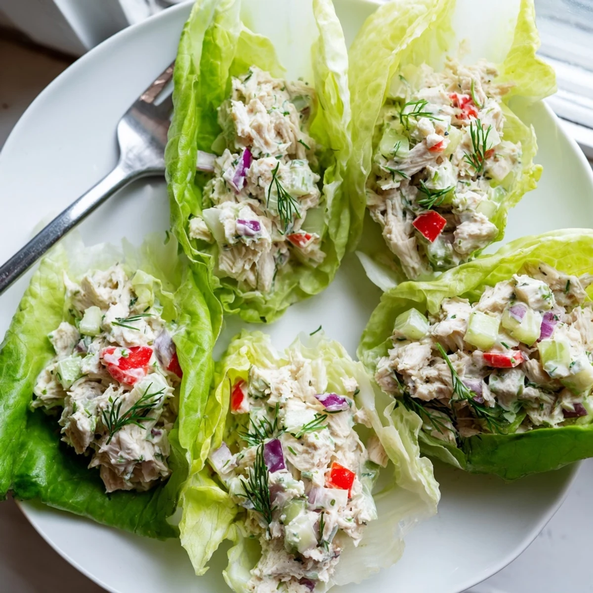 Creamy cottage cheese dill chicken salad spooned into crisp green butter lettuce wraps