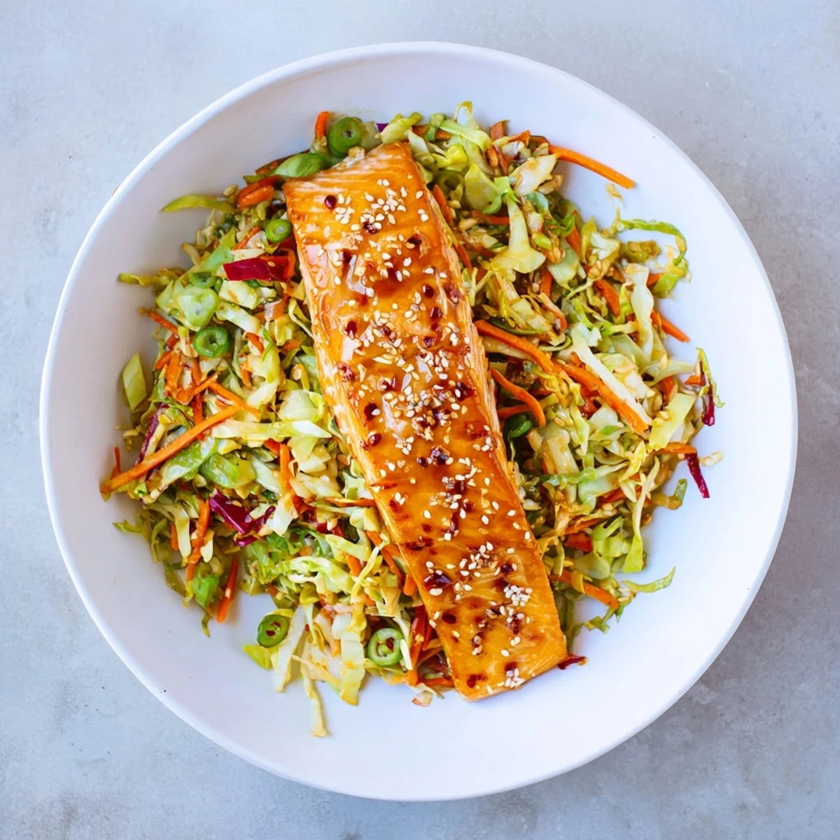 Juicy glazed miso ginger salmon fillets plated alongside vibrant crunchy sesame cabbage slaw