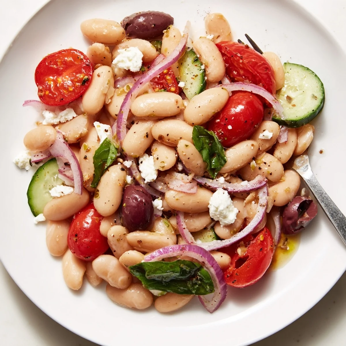 Bright Mediterranean White Bean and Tomato Basil Salad drizzled with zesty lemon vinaigrette.