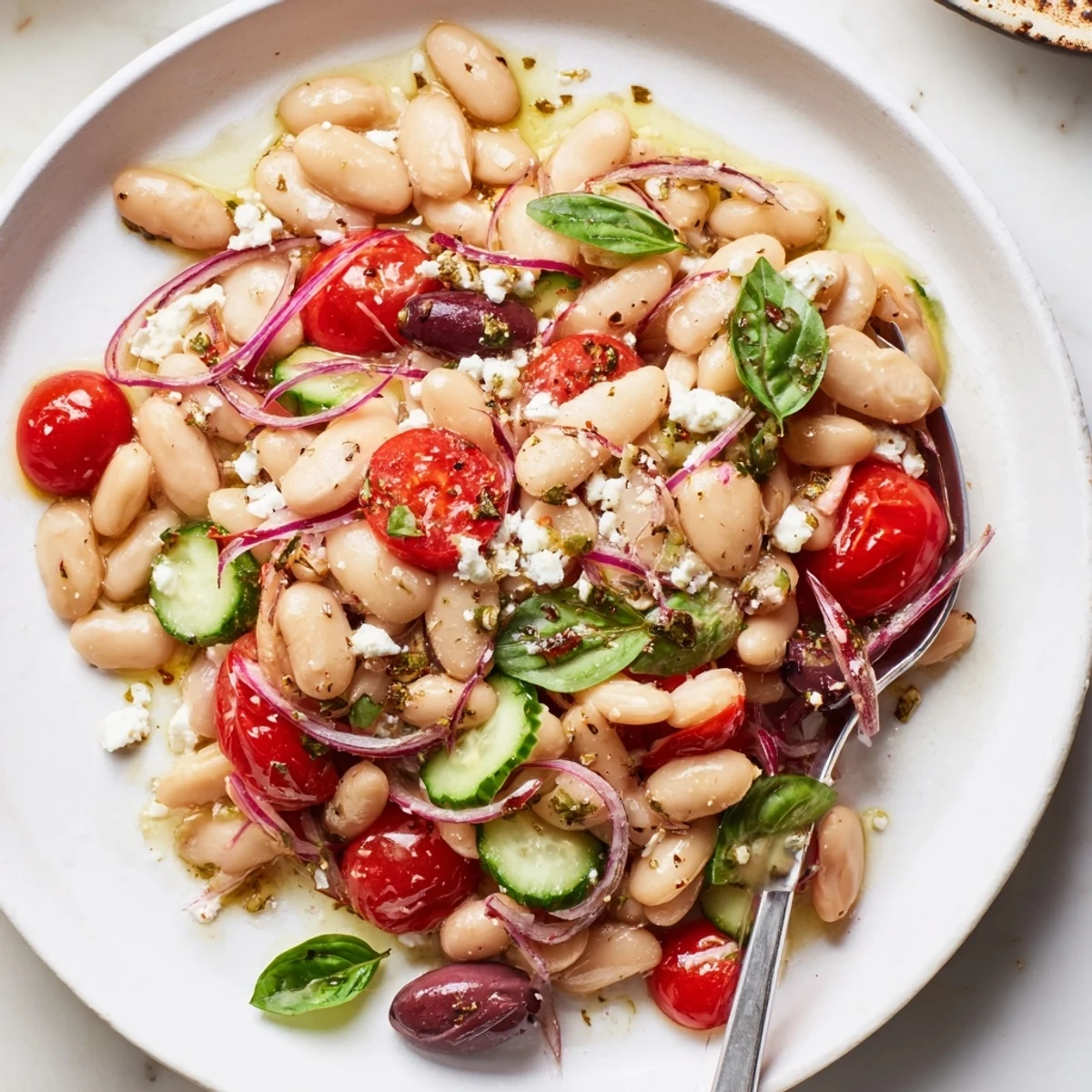 A chilled Mediterranean White Bean and Tomato Basil Salad served with warm crusty bread.