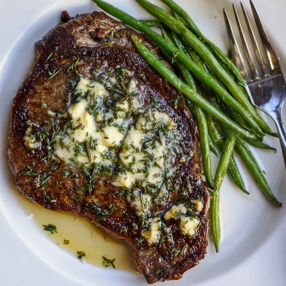Garlic Herb Steak With Roasted Green Beans resting, juicy steaks topped with herb jus