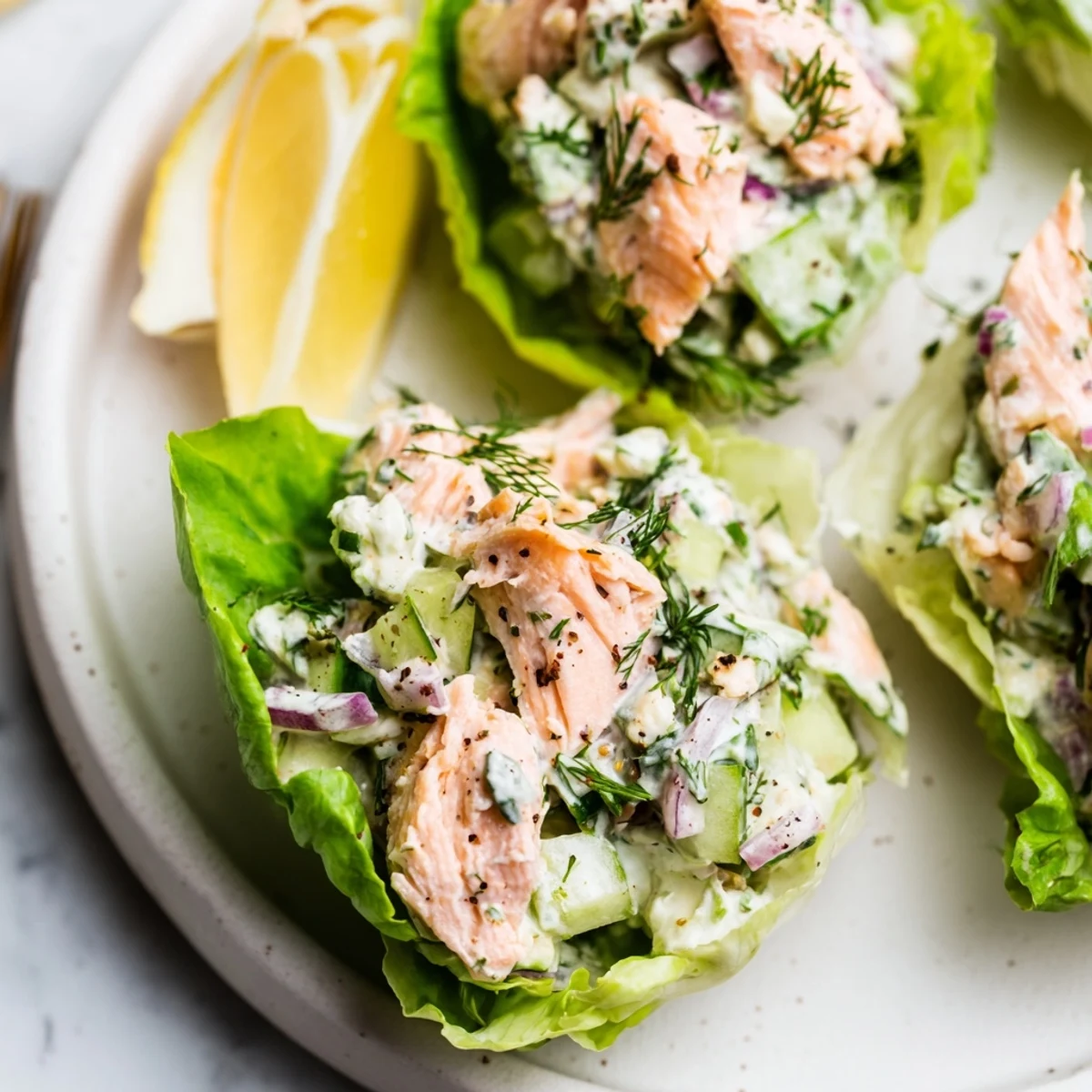 Crunchy lettuce holding Cottage Cheese Lemon Herb Salmon Salad Cups, creamy herb aroma