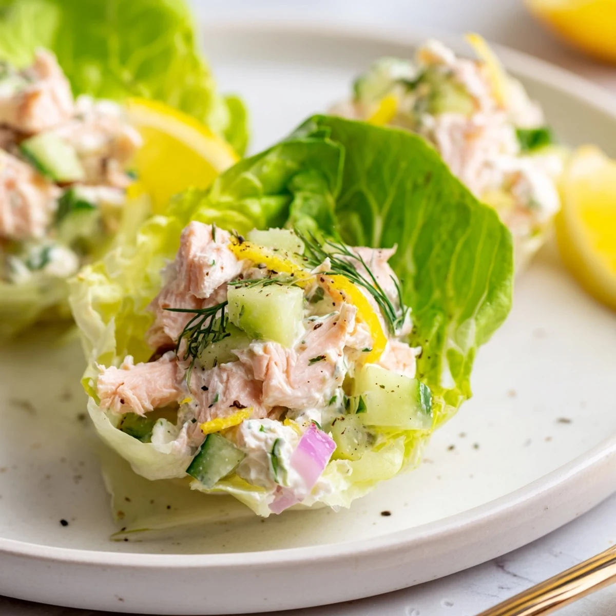 Cottage Cheese Lemon Herb Salmon Salad Cups arranged on platter, bright lemon wedges