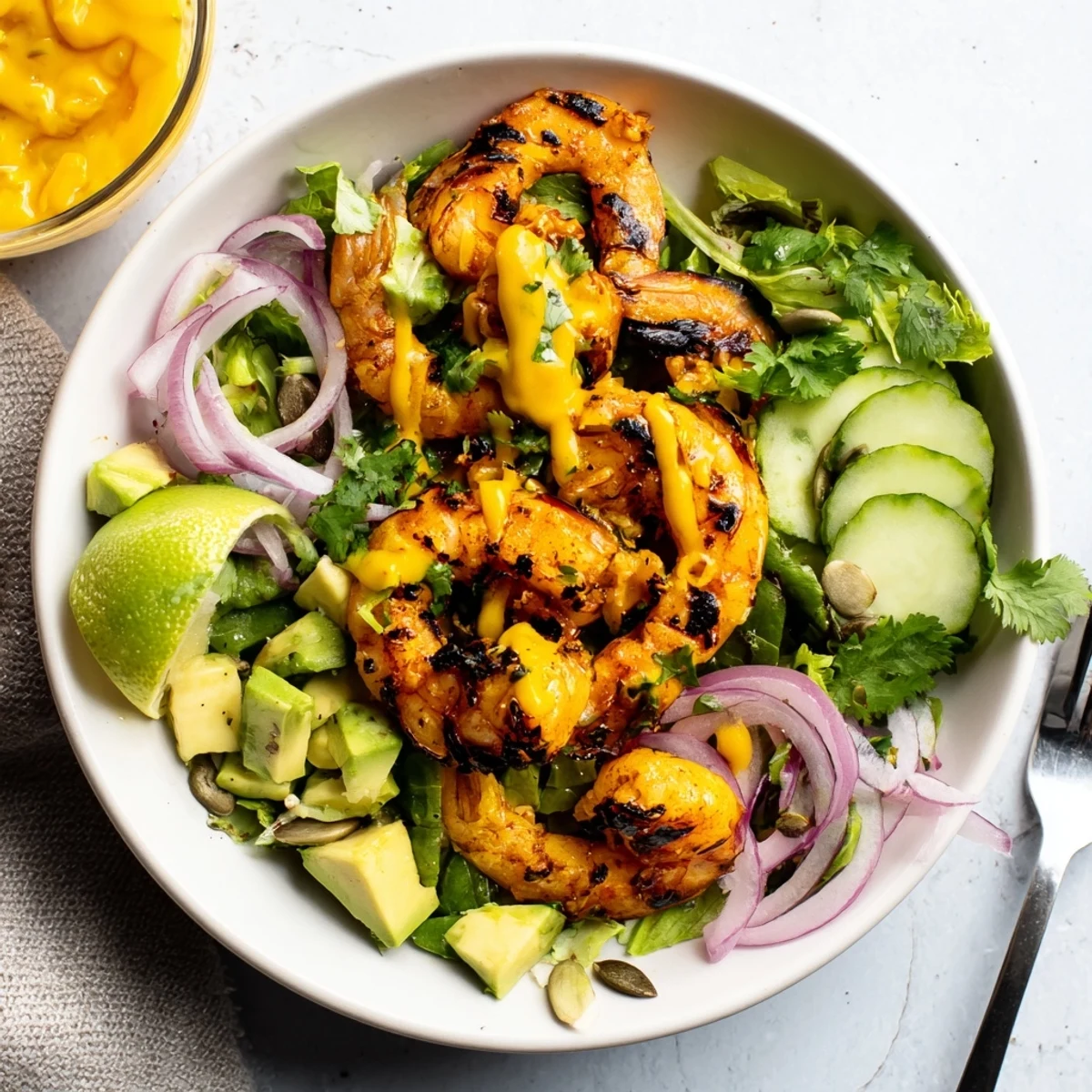 Sizzling skillet of garlicky, peppery shrimp — Spicy Mango Shrimp With Lime Avocado Crunch.