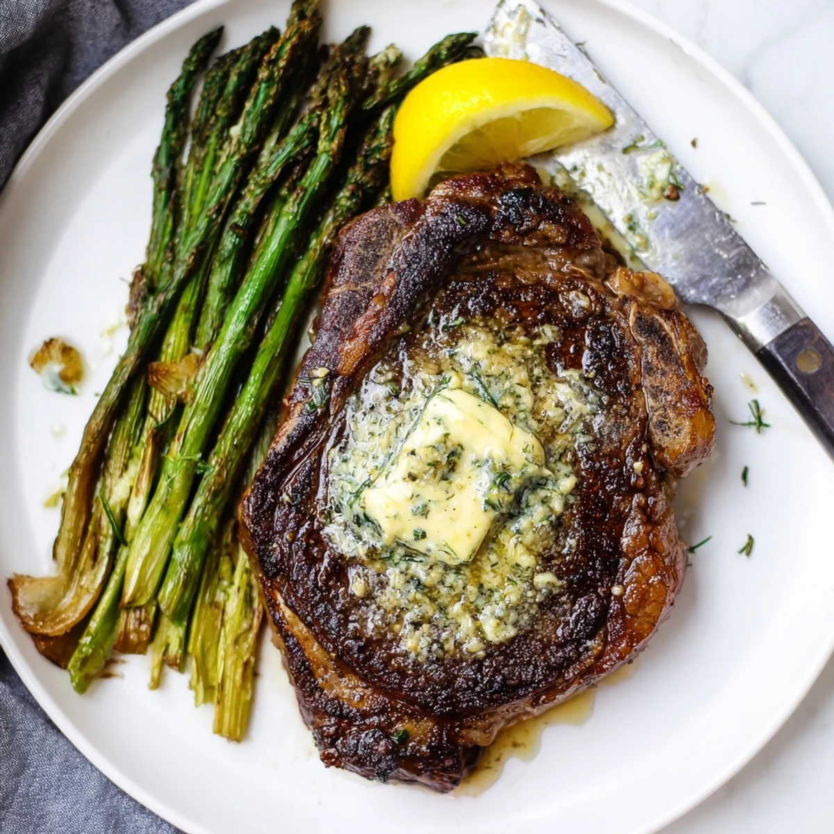 Garlic Herb Steak With Roasted Asparagus plated ready to serve, fragrant herb butter