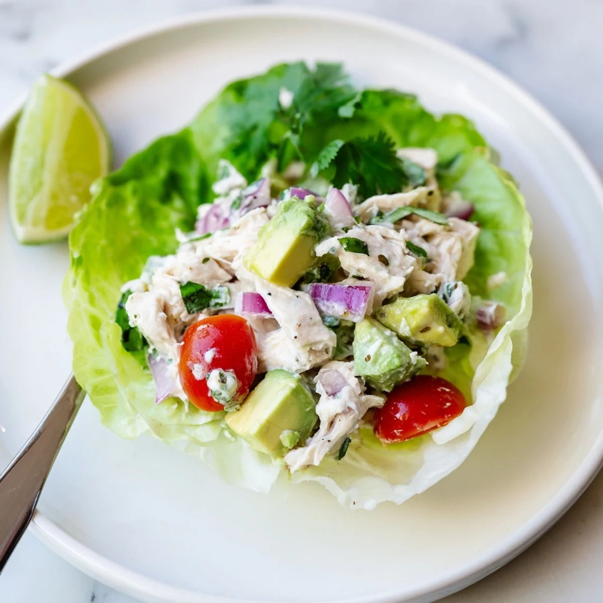 Freshly plated Cottage Cheese Avocado Lime Chicken Salad Cups garnished with cilantro