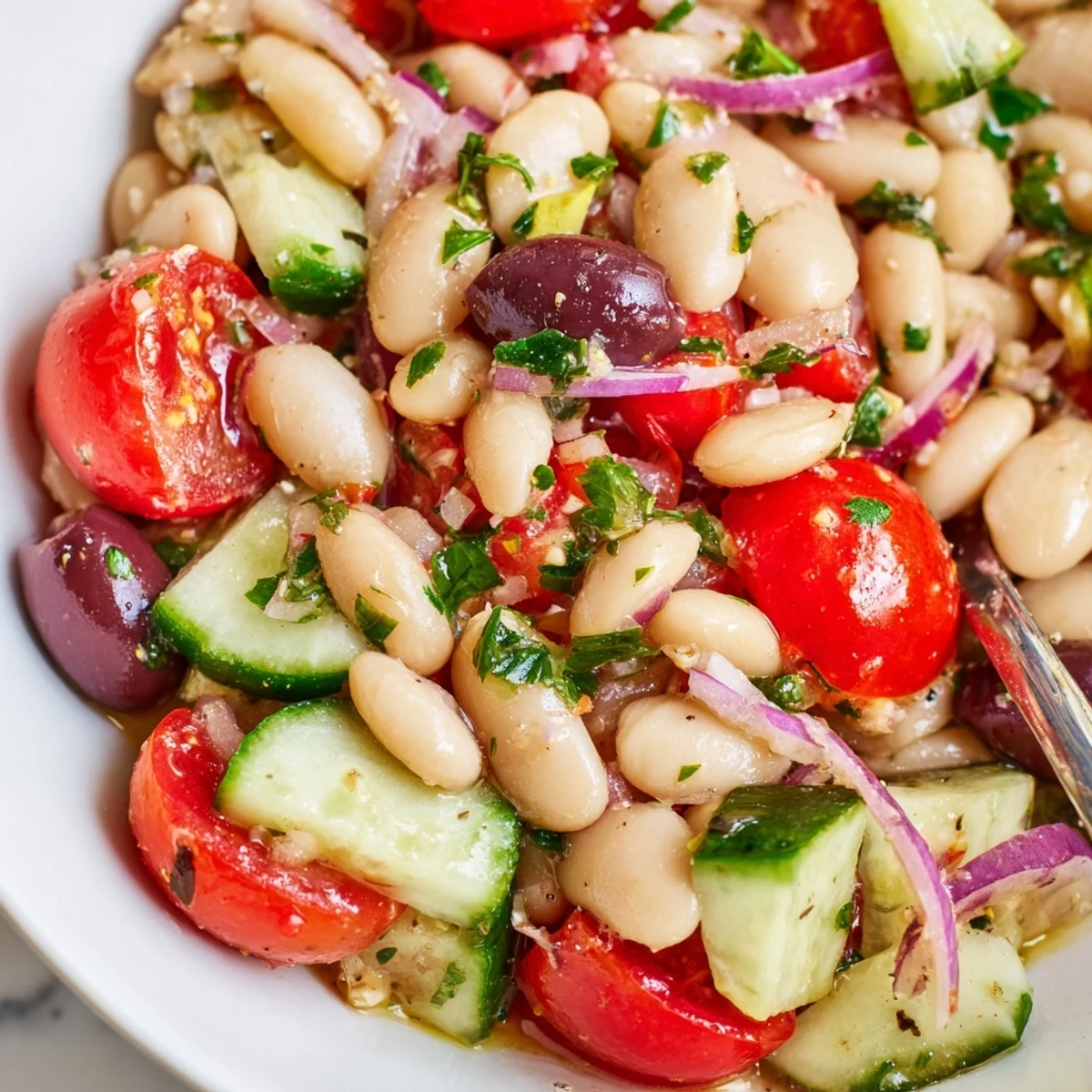 Mediterranean White Bean and Tomato Cucumber Salad glistening with lemon dressing, picnic-ready