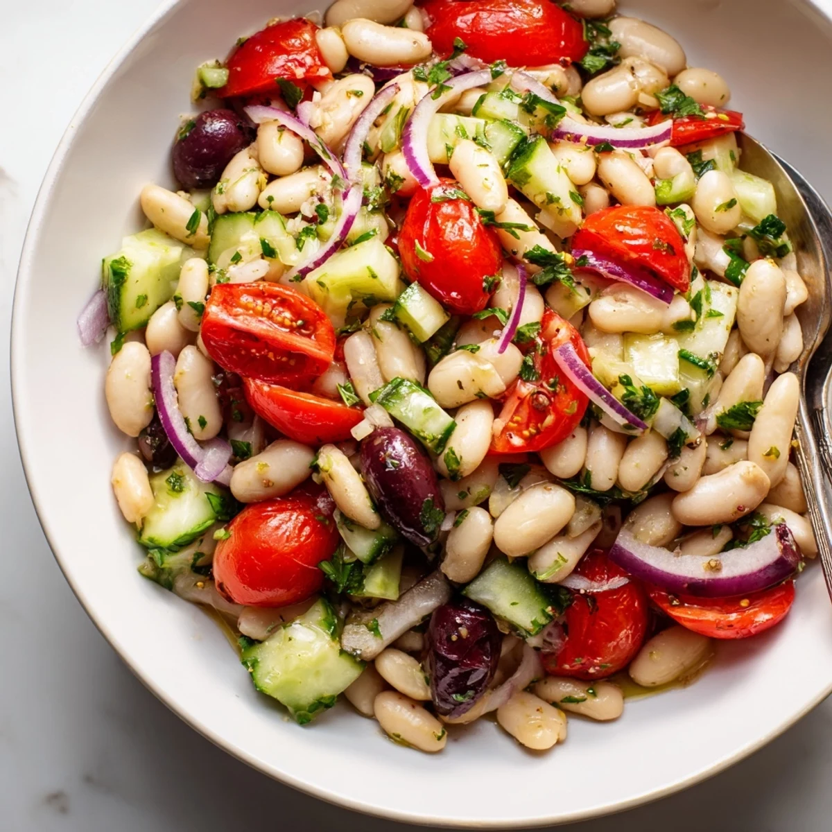 Tangy lemon dressing brightens Mediterranean White Bean and Tomato Cucumber Salad bowl