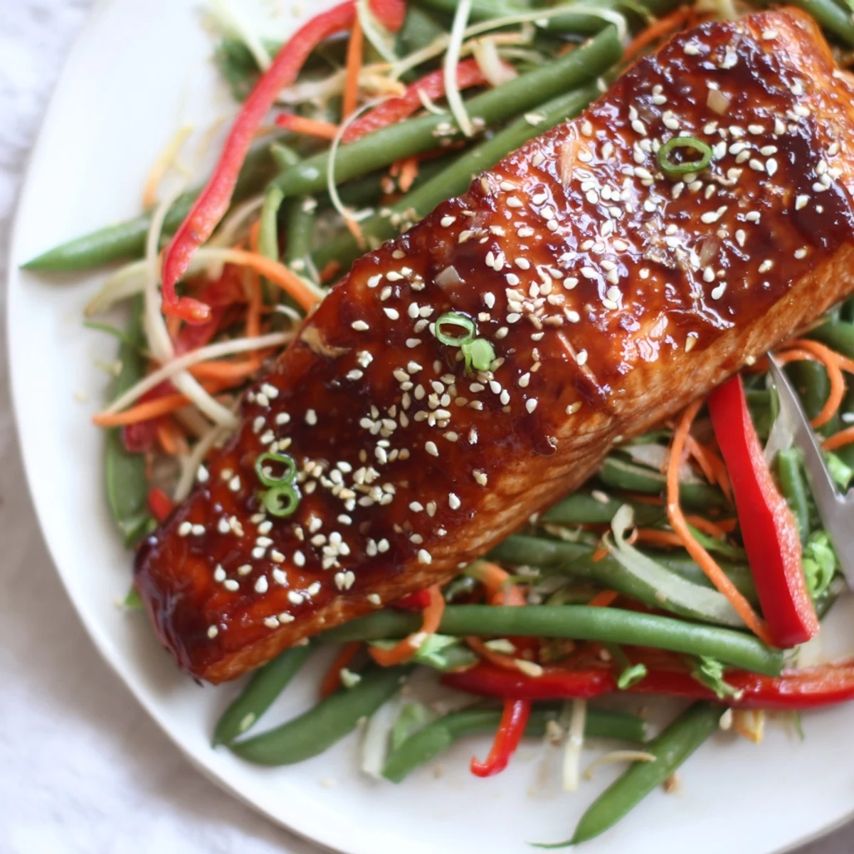 Baked Miso Ginger Salmon With Sesame Green Bean Slaw served with lime.