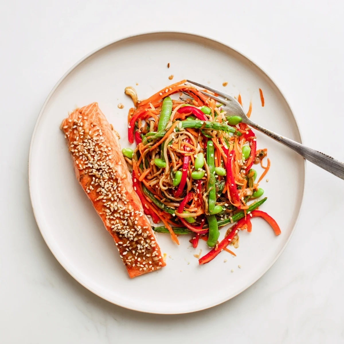 Golden glazed miso citrus salmon fillets served with vibrant green snap pea slaw