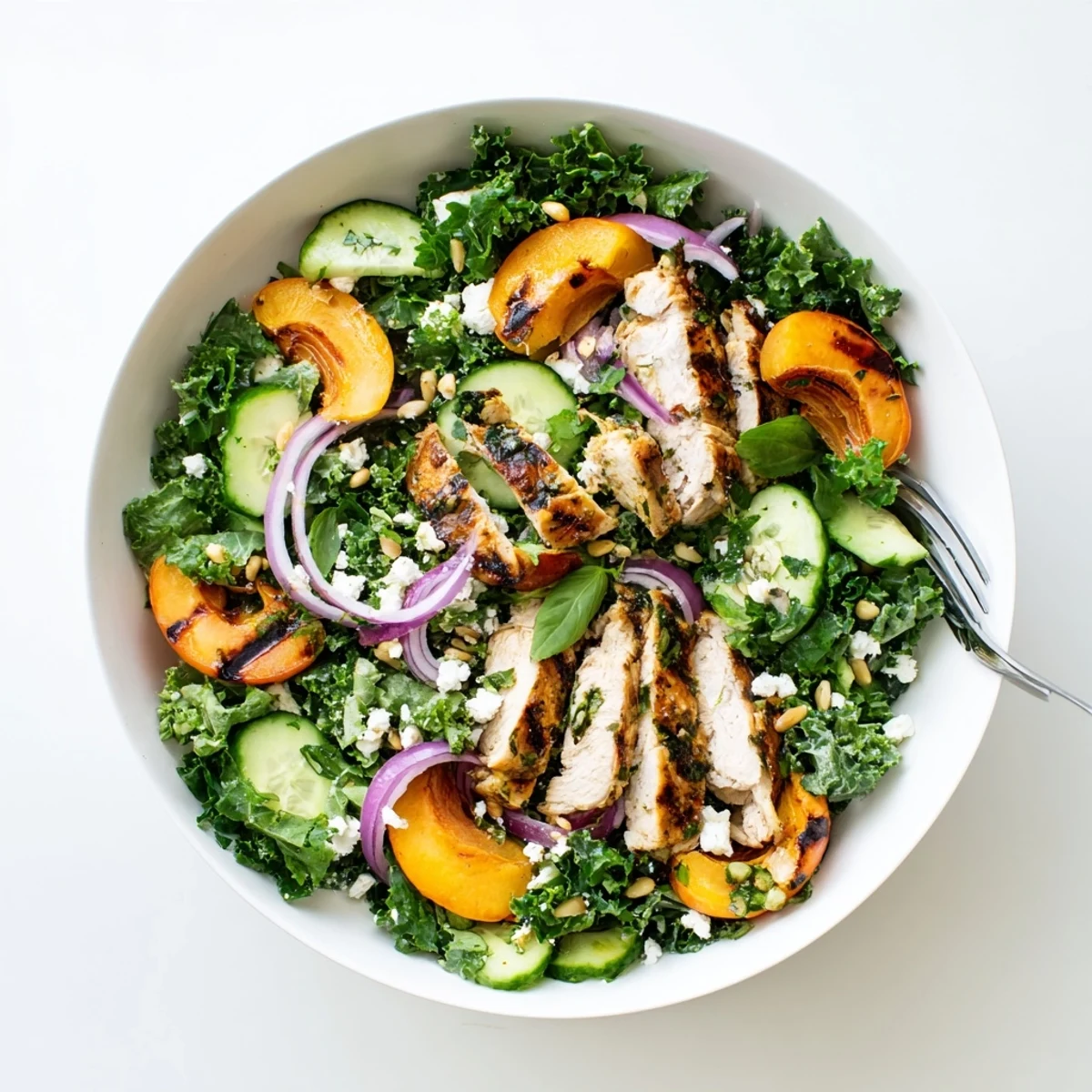 Grilled apricot and kale chicken salad topped with fresh basil and honey lemon vinaigrette