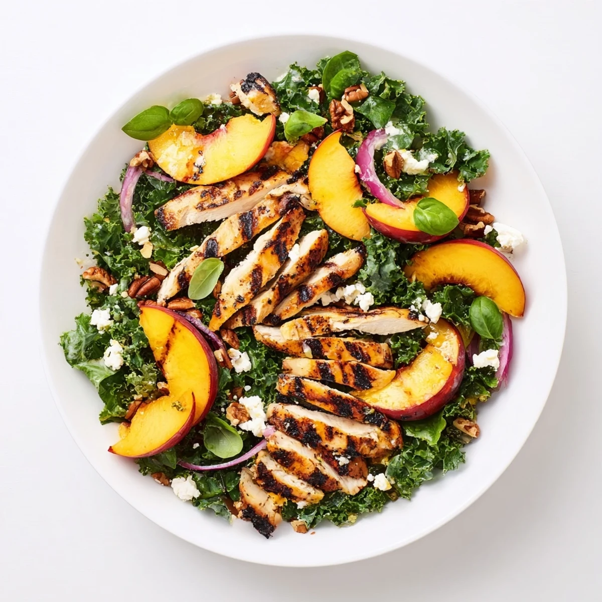 Fresh grilled nectarine and kale chicken salad tossed with zesty lemon vinaigrette and crumbled feta cheese