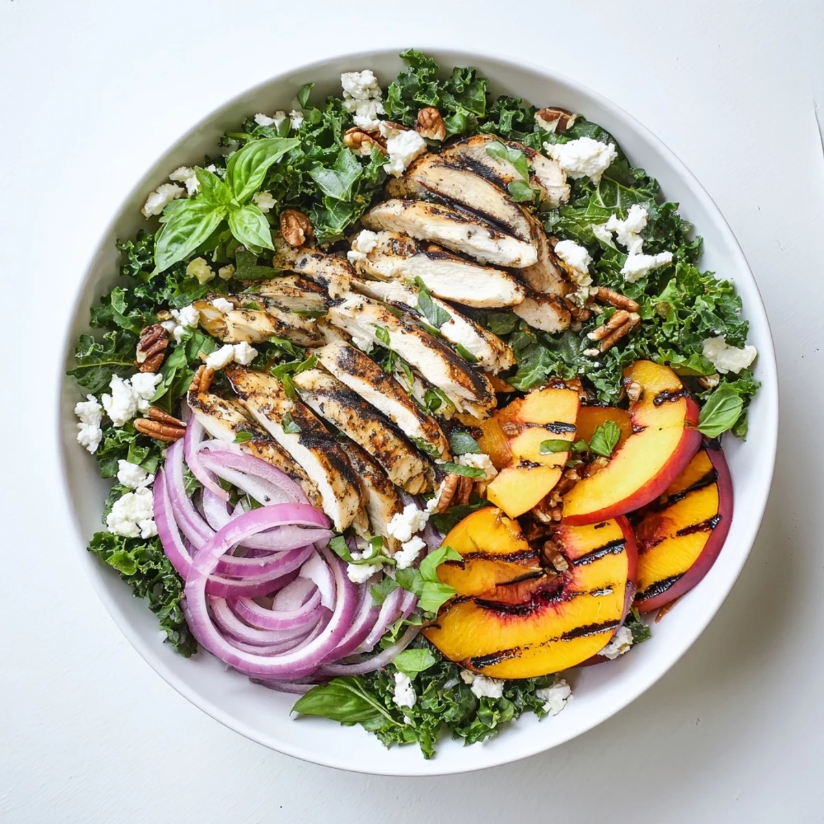 Smoky grill marks top Grilled Peach and Kale Chicken Salad with Mint & Basil