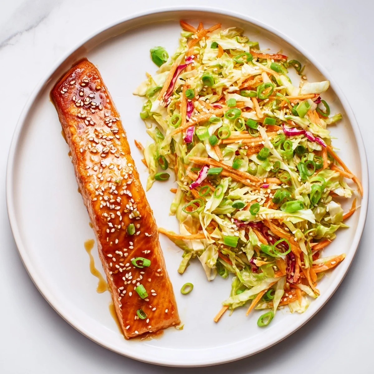 Baked Miso Maple Salmon With Sesame Cabbage Slaw plated atop steamed jasmine rice