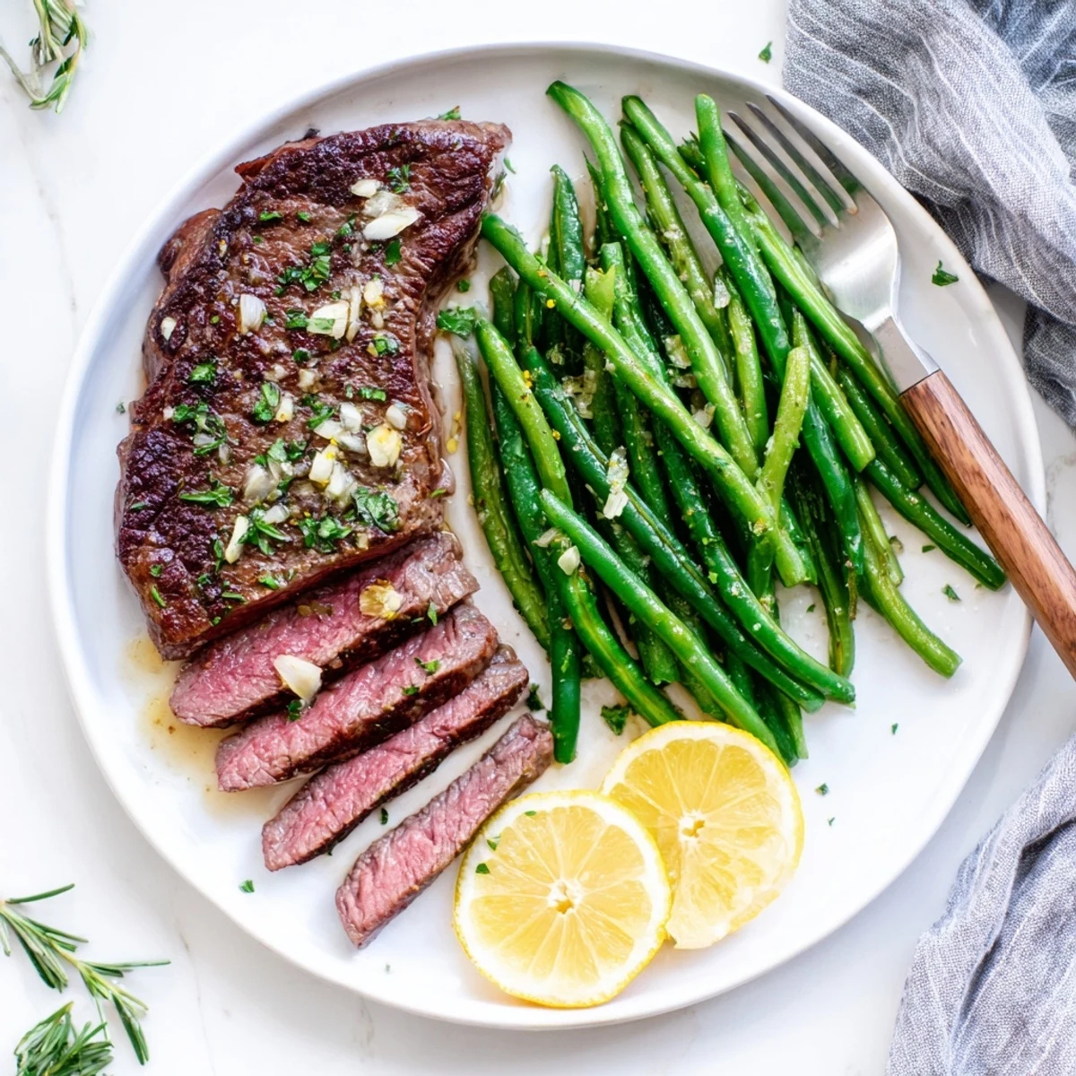Resting Garlic Herb Steak with Roasted Green Beans and Lemon, garlic butter sheen