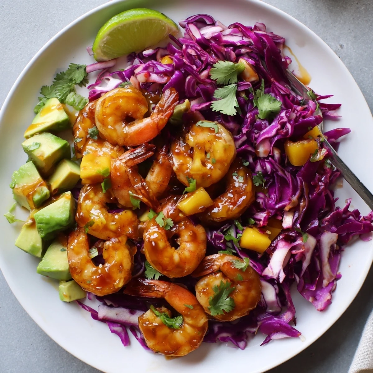 Close-up Spicy Mango Shrimp With Lime Avocado Cabbage Crunch showing vibrant textures and creamy avocado