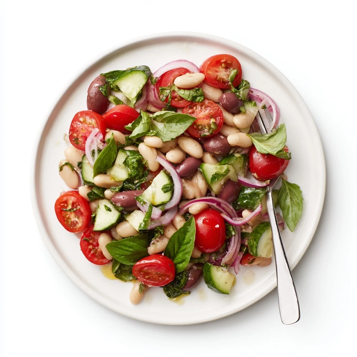 Creamy white beans tossed with juicy cherry tomatoes crisp cucumber and fresh basil in a zesty lemon olive oil dressing