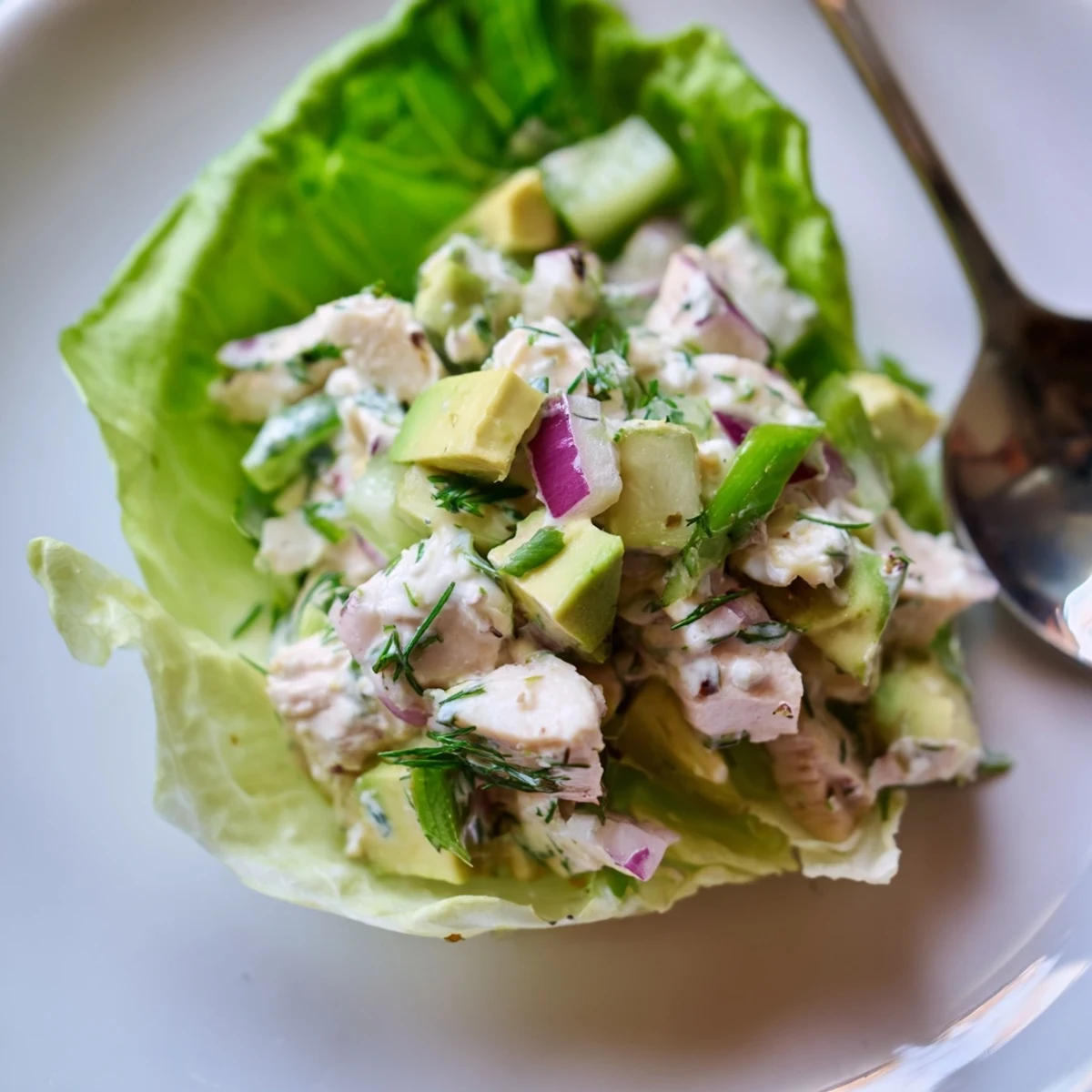 Hearty Cottage Cheese Avocado Herb Chicken Salad Cups topped with lemon zest and dill