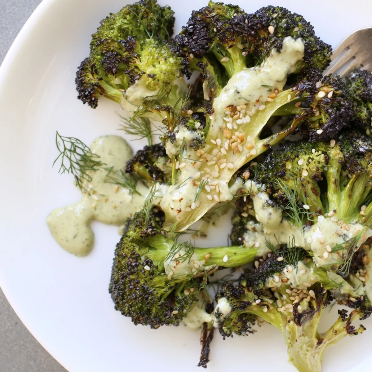Plated Roasted Broccoli With Lemon Herb Tahini Sauce, garlicky lemon tang and parsley