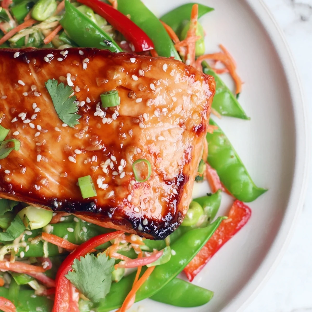 Miso Ginger Salmon With Sesame Snap Pea Slaw, glazed flaky fillet