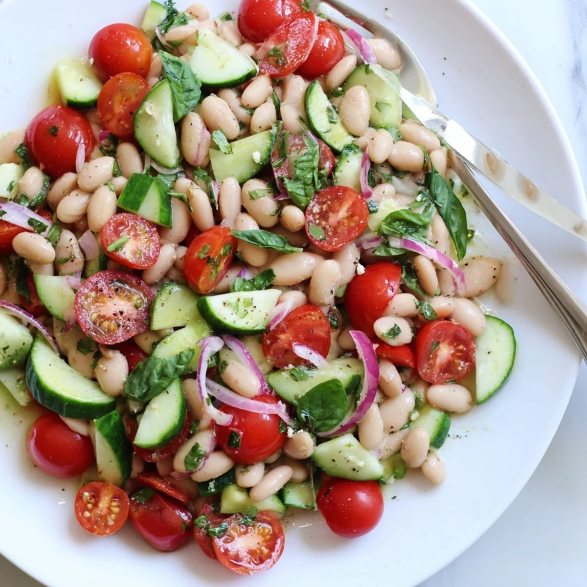 Mediterranean White Bean and Tomato Basil Cucumber Salad tossed in zesty lemon olive dressing