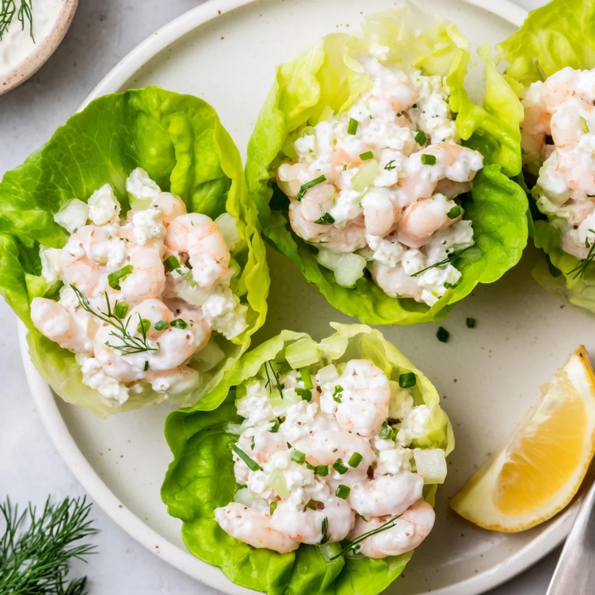 Bright Cottage Cheese Lemon Dill Shrimp Salad Cups topped with chopped fresh chives.