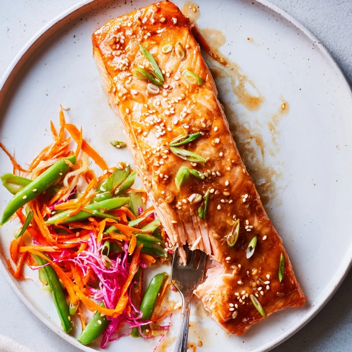 Glazed Miso Ginger Salmon With Sesame Snap Pea Slaw, flaky and caramelized.