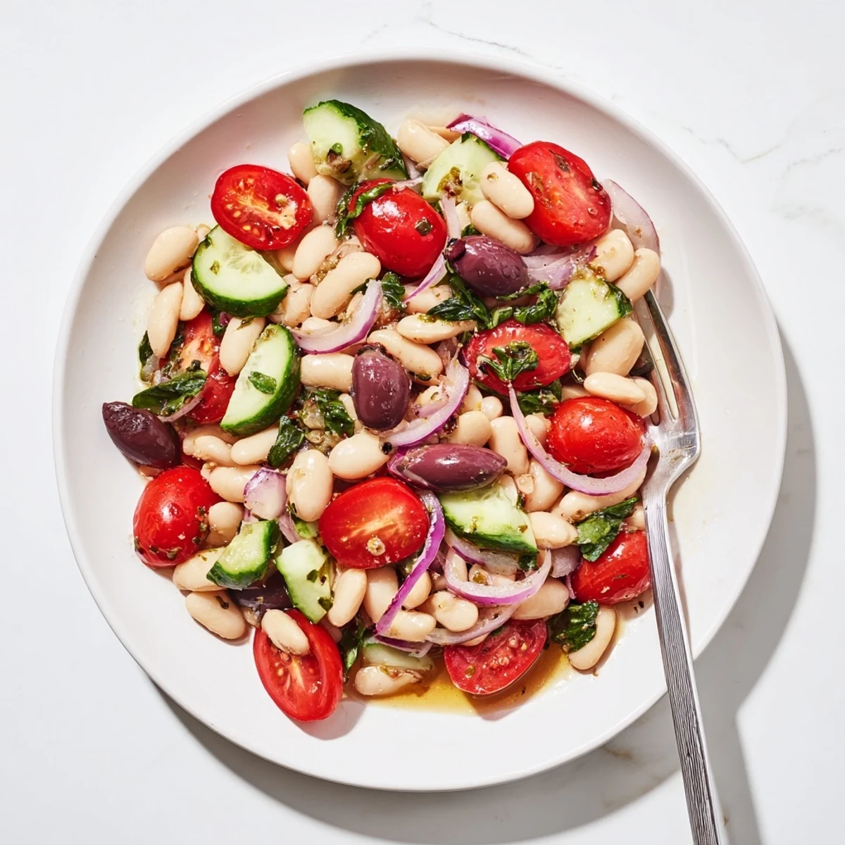 Creamy white beans and juicy tomatoes star in this Mediterranean white bean and tomato basil salad