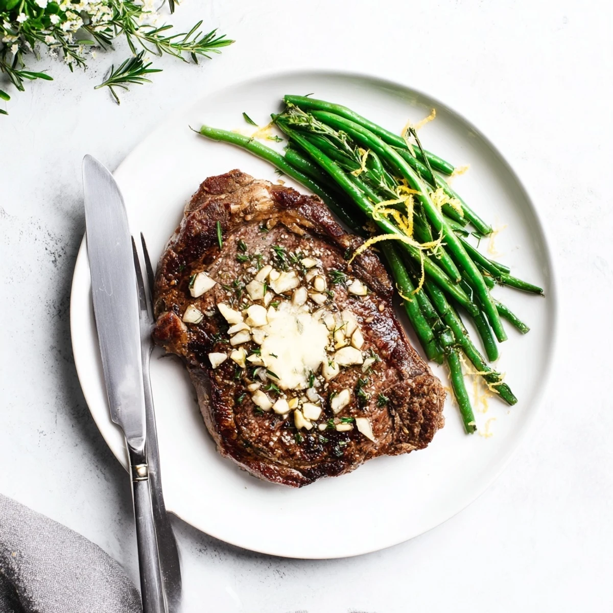 Perfectly seared garlic herb steak with roasted green beans drizzled in bright lemon butter