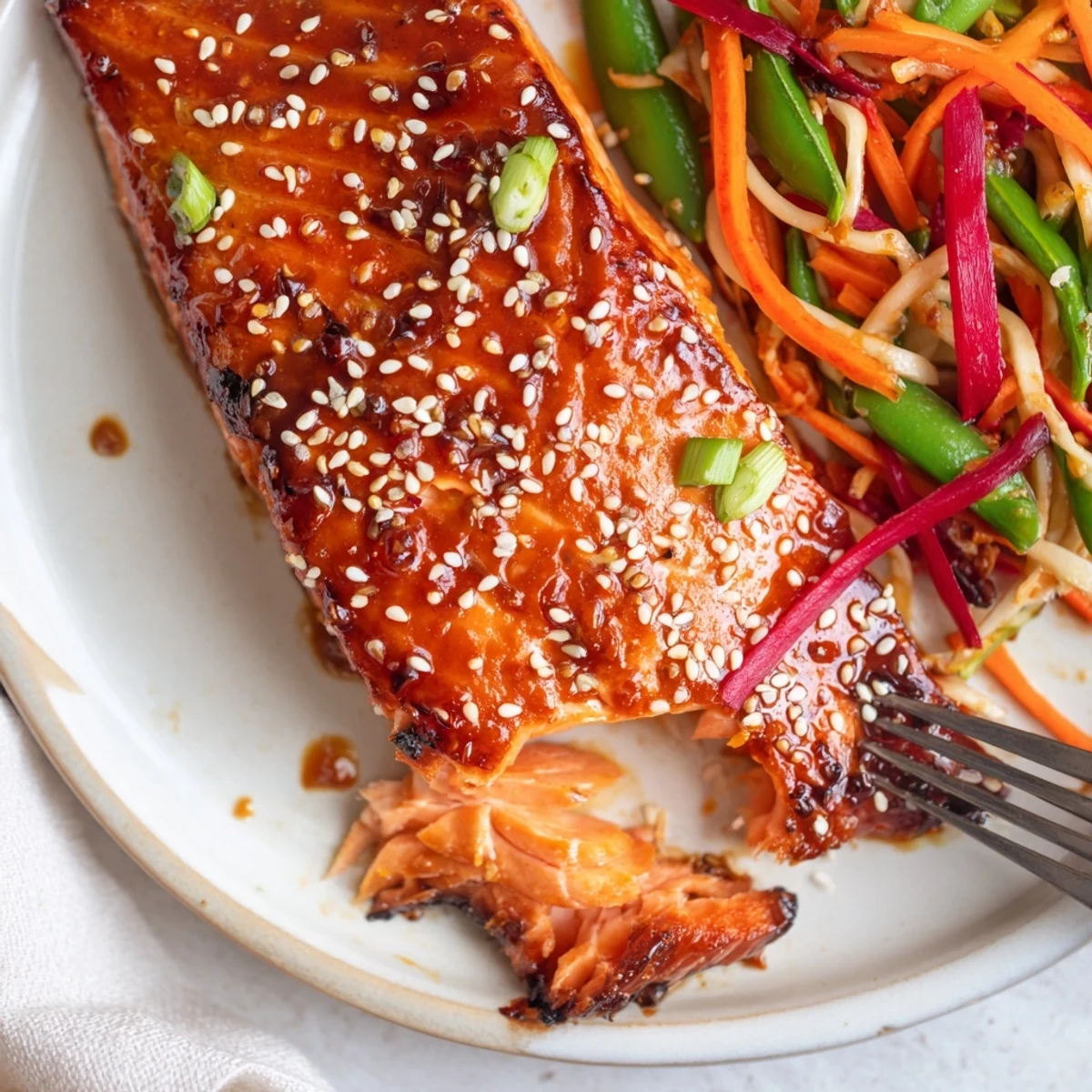 Glazed Miso Ginger Salmon With Sesame Snap Pea Slaw, flaky and caramelized.