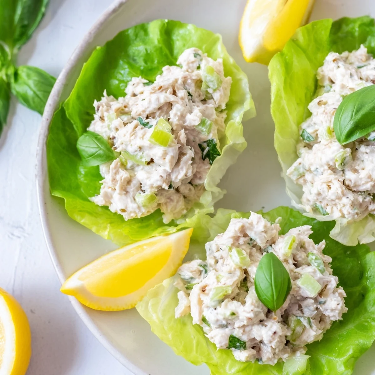 Tangy lemon basil tuna salad spooned into crunchy green lettuce cups ready to eat