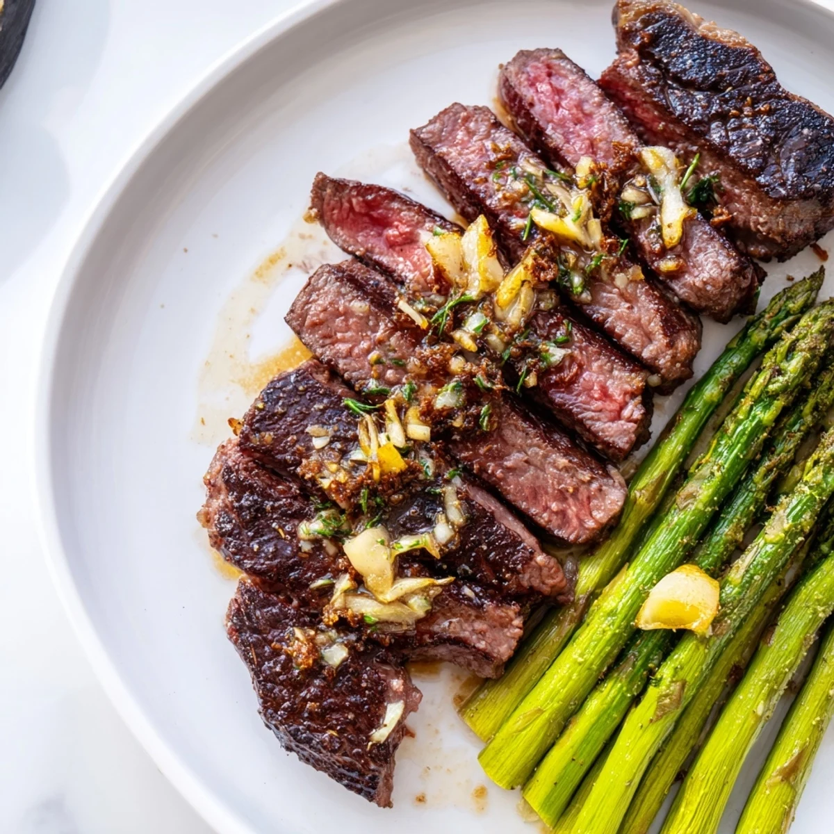Juicy garlic herb steak with roasted asparagus and lemon served on a rustic wooden board
