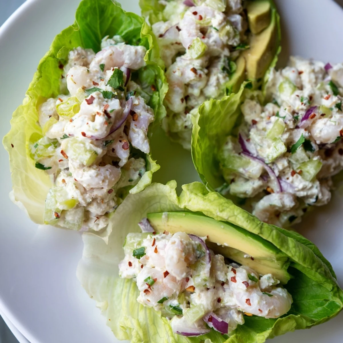 Creamy cottage cheese lemon basil shrimp salad spooned into crisp green lettuce cups