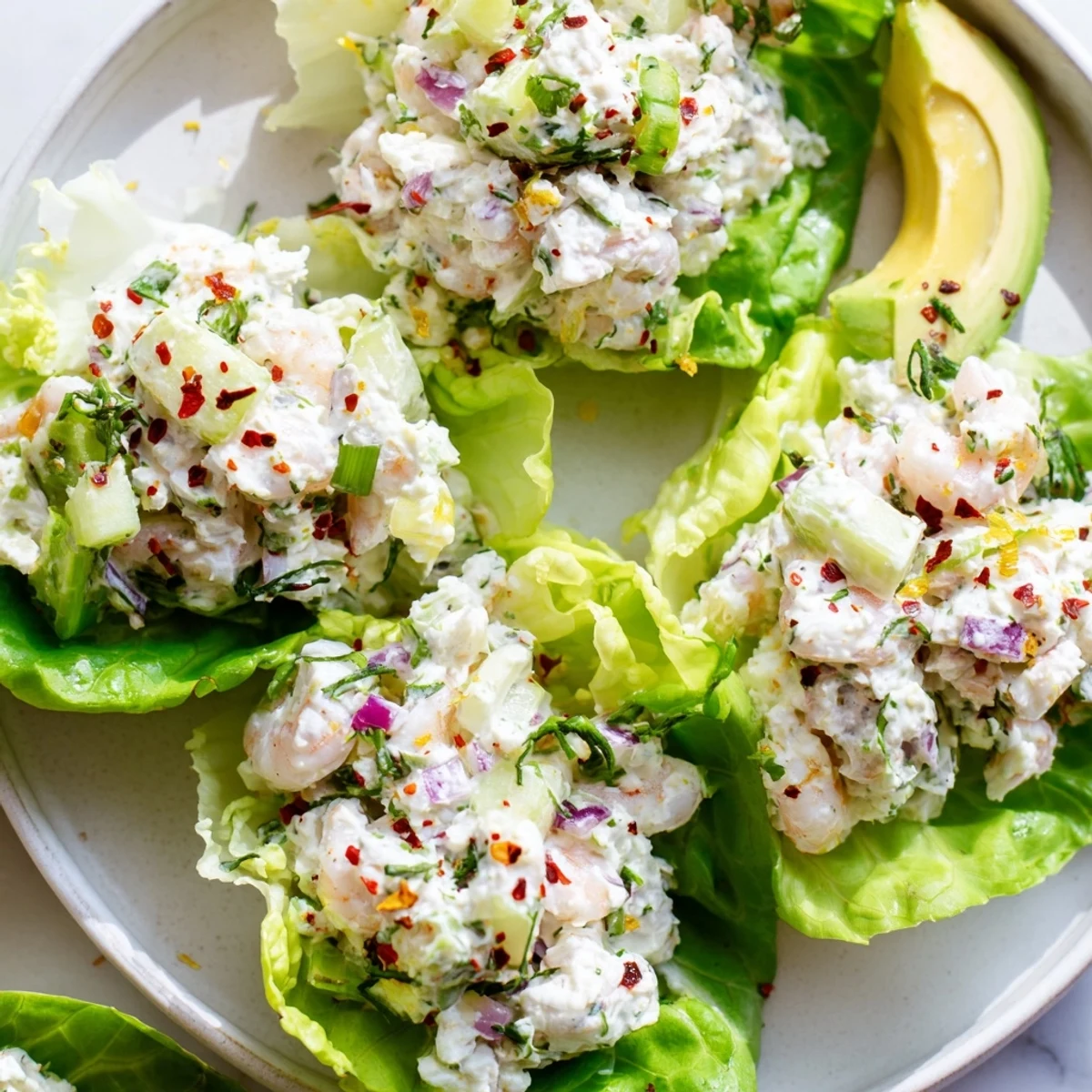 Tender pink shrimp with zesty lemon and basil nestled in butter lettuce cups