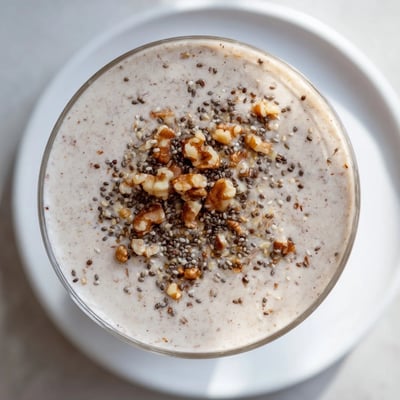 Close-up of a thick, berry-swirled Winter Harvest Keto Smoothie, ready to enjoy with a straw.